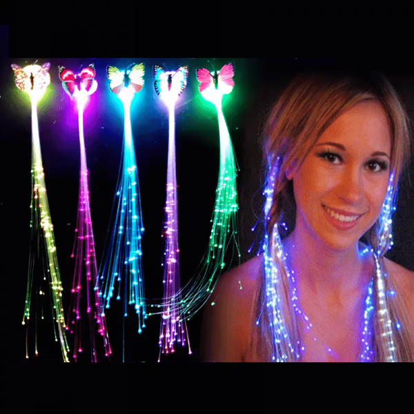 A smiling person wears LED Hair Extensions glowing with multicolored lights, alongside five butterfly-shaped fiber optic accessories in various hues displayed on the left. The dark background enhances the vibrant illumination of these LED Hair Extensions.