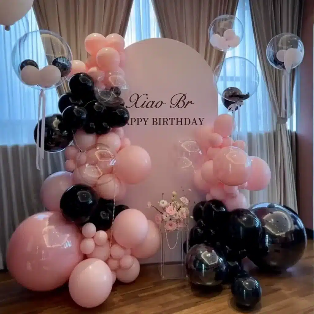 Black and pink themed birthday balloon setup with backdrop in Singapore