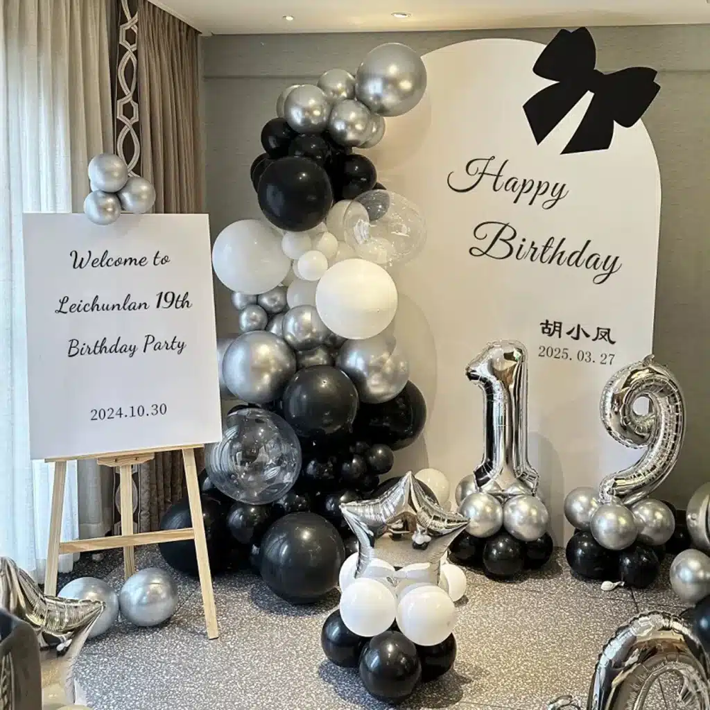 Elegant black, white, and silver 19th birthday balloon decoration setup in Singapore