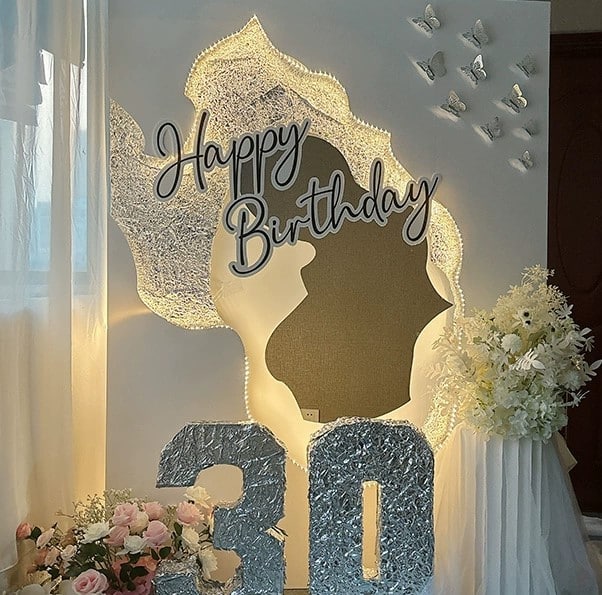 Luxury birthday backdrop with floral arrangements, 30th birthday signage, and silhouette cut-out in Singapore