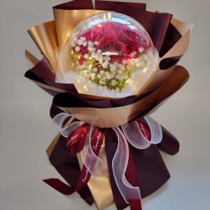 artificial red roses inside LED acrylic dome bouquet
