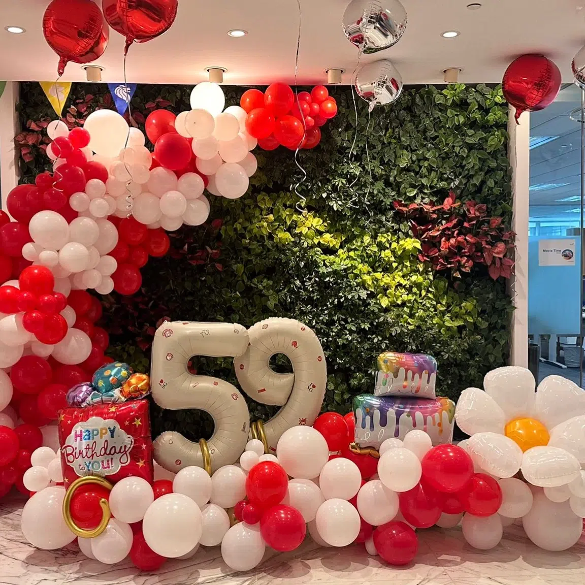Red and white corporate balloon decoration for Singapore National Day event with custom balloon backdrop